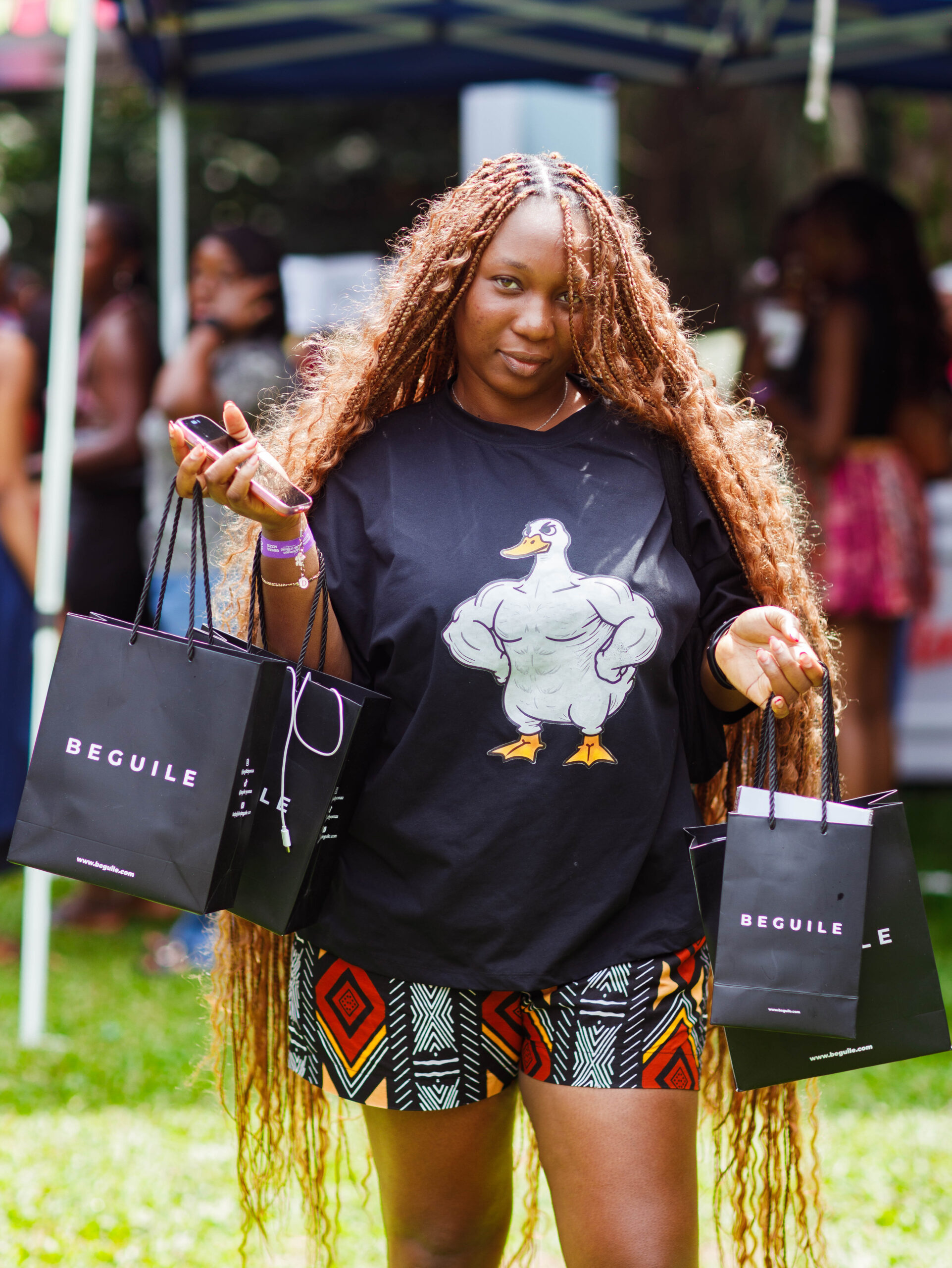 Shoppers leave Beguile's Abuja pop-up carrying multiple fragrance shopping bags
