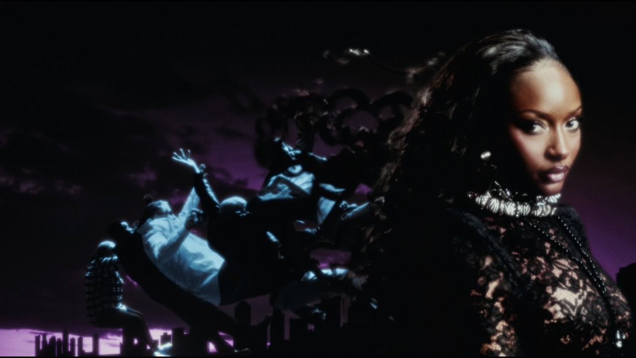 Ayra Starr in a black lace top against a purple sky, next to a surreal scene of a frozen crowd suspended above a miniature city skyline