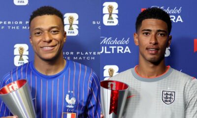 Kylian Mbappé holding the silver FIFA Player of the Match trophy next to Jude Bellingham holding his respective Michelob Ultra Player of the Match award.