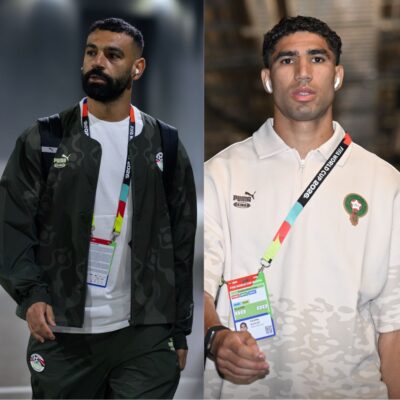 Egypt's Mohamed Salah and Morocco's Achraf Hakimi wearing official national team apparel and tournament passes at the World Cup.