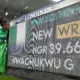 Goodness Nwachukwu posing beside the Longines scoreboard displaying her 39.66m F42 discus world record at Glasgow 2026.