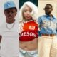 Victony wearing a light blue LA baseball cap, Fave in platinum blonde hair and a red Jameson top, and Adekunle Gold in a blue floral shirt with Louis Vuitton belt.