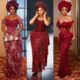 Ini Edo in a gold-embroidered burgundy lace gown alongside Liquorose in a wine-red beaded corset gown with coral beads and Toke Makinwa in a sequined peplum corset dress at Soso Soberekon's wedding.