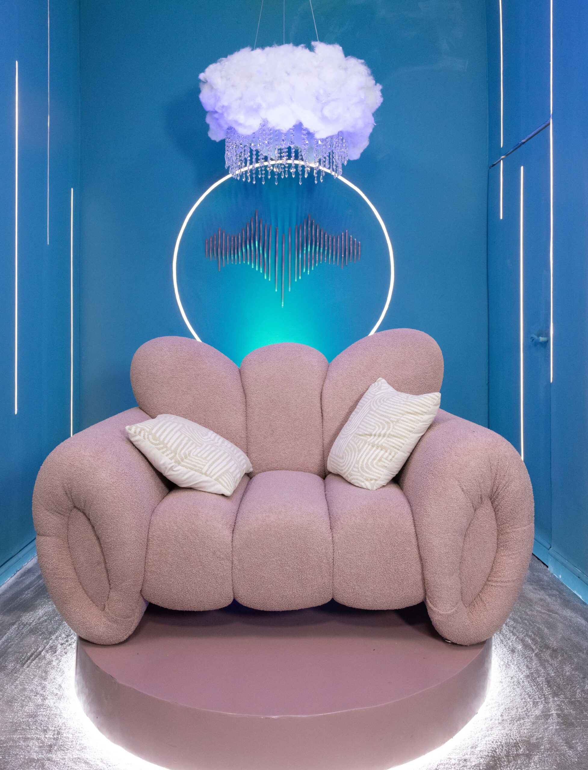 Official Big Brother Naija Season 11 Diary Room featuring a plush pink armchair, illuminated neon halo ring, and cloud chandelier