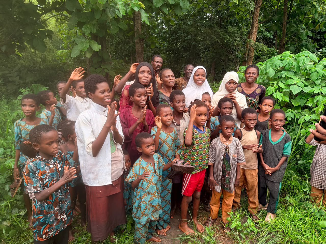 Rescued school pupils and teachers standing together in a forested area following their release in Orire Local Government Area.
