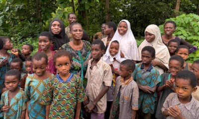 Abducted school children and female teachers gathered among green foliage following a 56-day captivity ordeal in Oyo State.