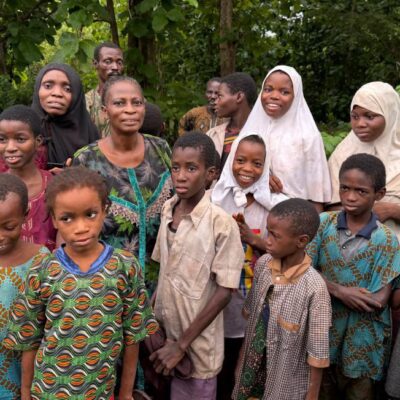 Abducted school children and female teachers gathered among green foliage following a 56-day captivity ordeal in Oyo State.