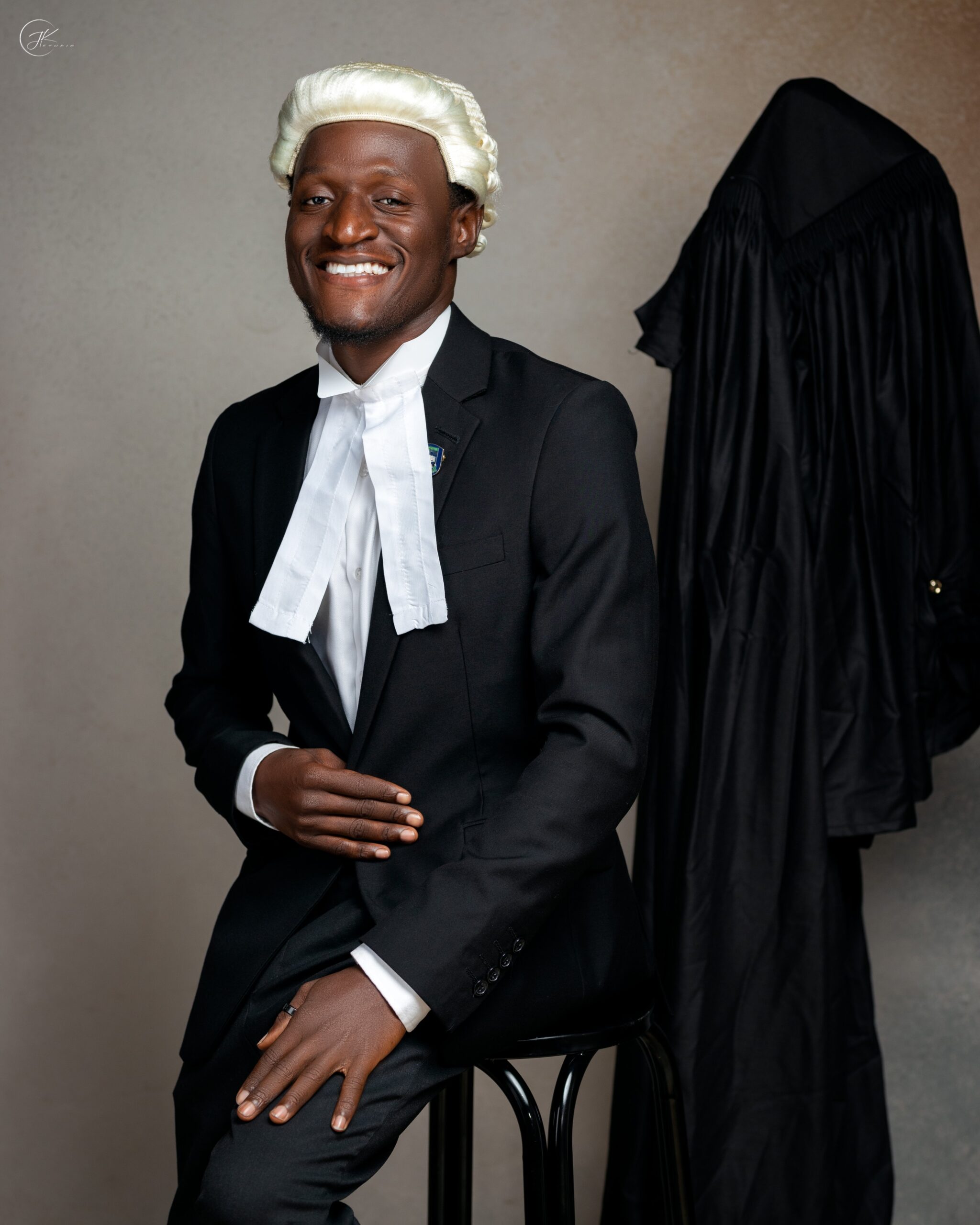 Nehemiah Shanum Danjuma wearing a white legal wig, bands, and a dark suit during the Call to the Bar ceremony.