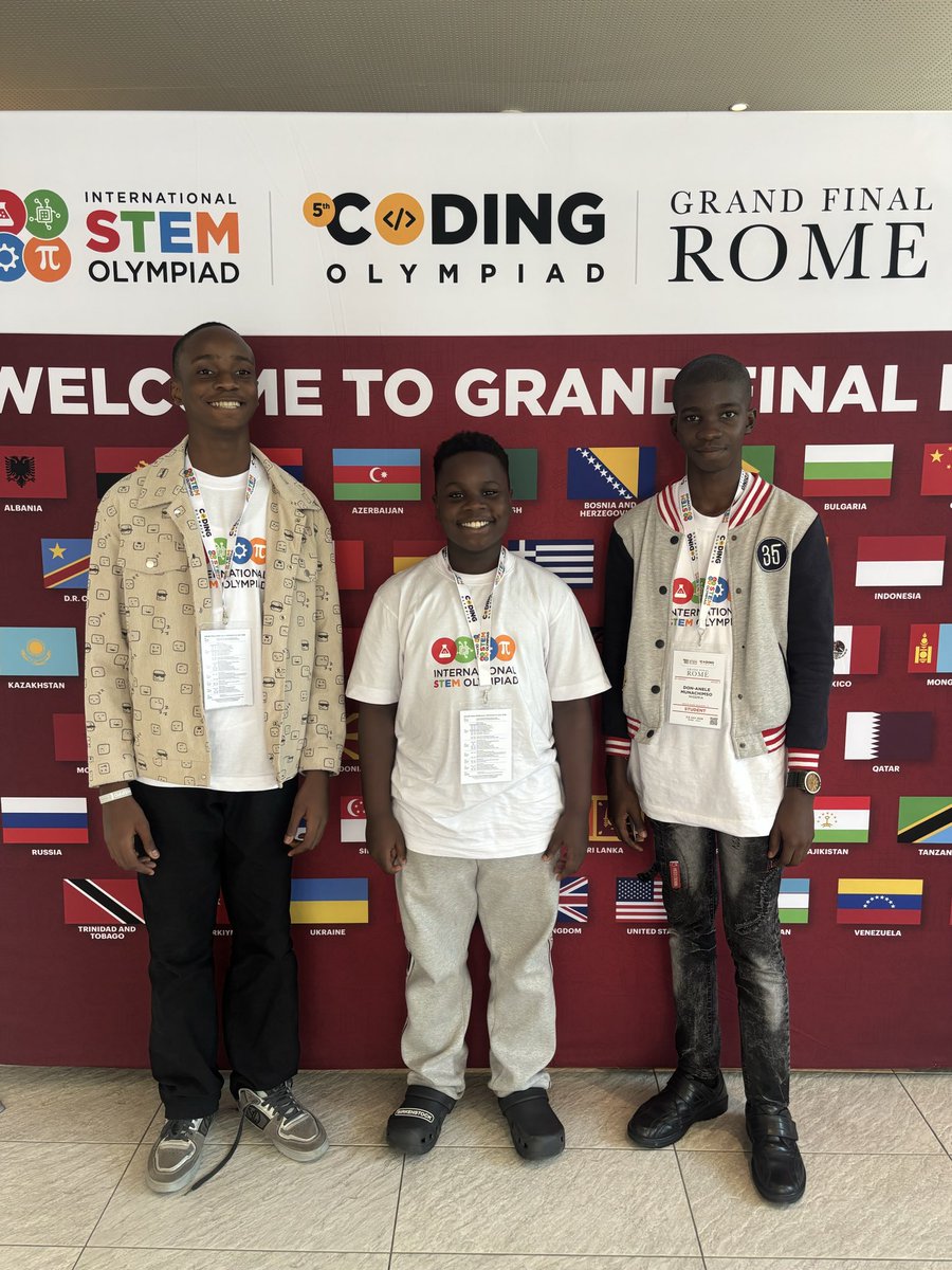 Chimdiebube Onwubiko, Egejurum Onyedikachi Ethan, and Don Anele Munachimso Marvelous wearing event badges in front of the International STEM Olympiad Grand Finale Rome welcome banner.
