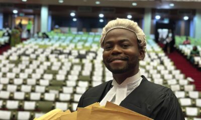 Israel Adeniyi Adekunle displaying a fan of brown award envelopes, including his Council of Legal Education Star Prize, at the Nigerian Law School.
