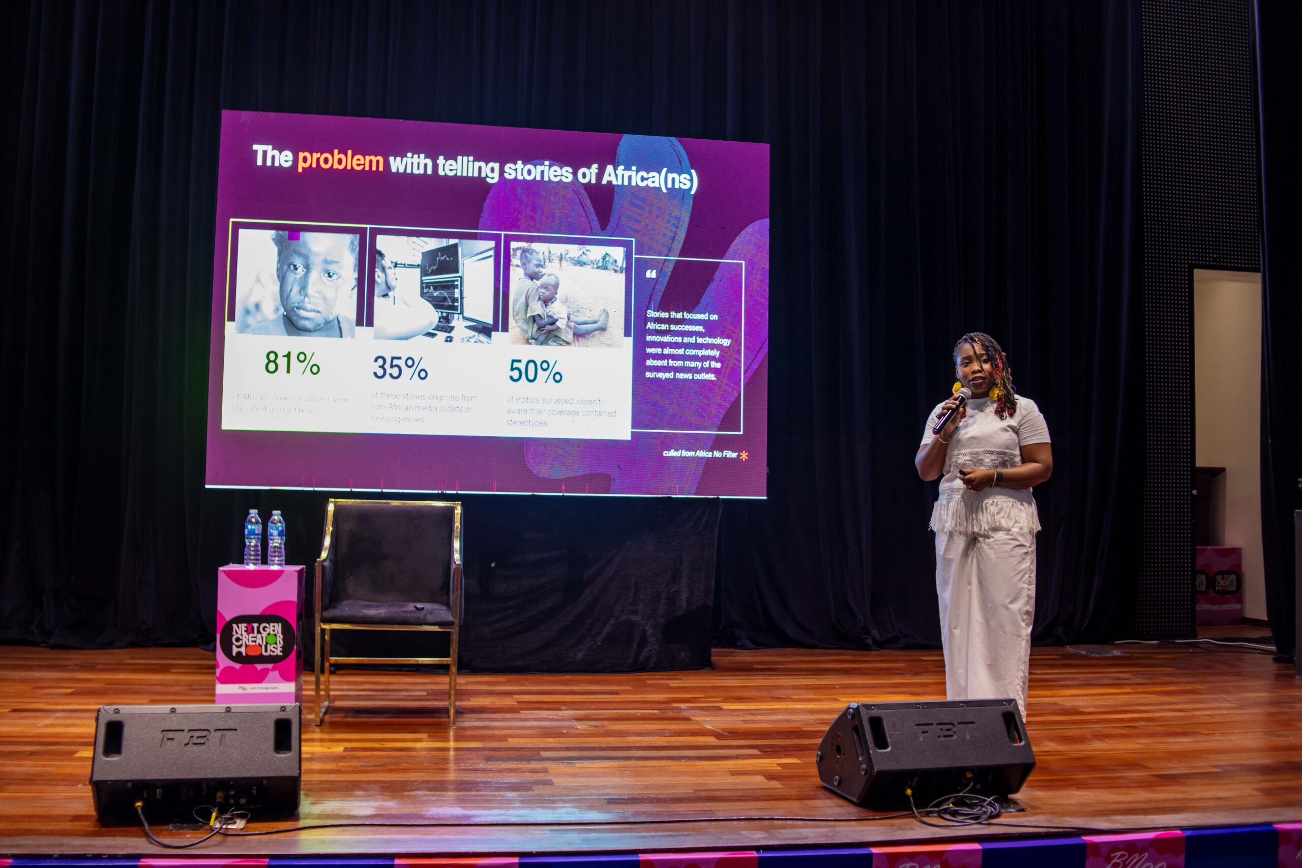 Head of Editorial and Innovation Oluwadunsin Sanya speaking on stage in front of a slide titled "The problem with telling stories of Africa(ns)".