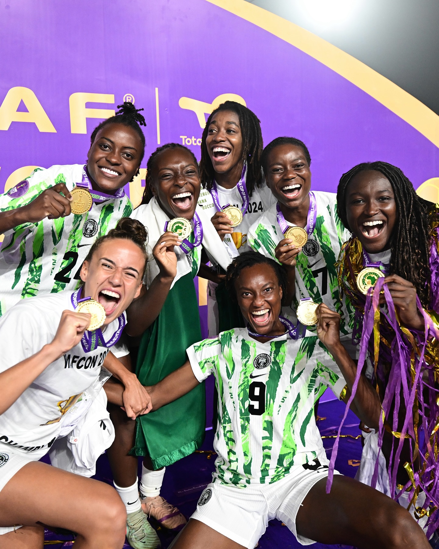 Nigeria Super Falcons players Asisat Oshoala, Ifeoma Onumonu, Deborah Abiodun, Ashleigh Plumptre, Toni Payne, and Jennifer Echegini displaying gold winner medals after defeating Morocco in the 2024 WAFCON final.