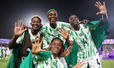 Nigeria's Super Falcons players, including Rasheedat Ajibade and Asisat Oshoala, smiling and celebrating on the pitch.