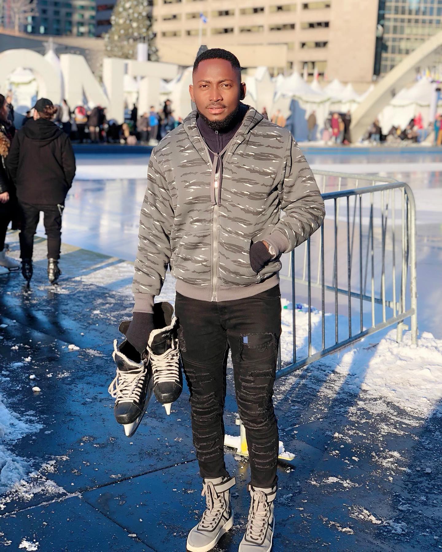 Miracle Igbokwe holding ice skates outdoors following his Big Brother Naija Season 3 victory.