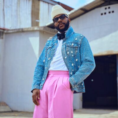 Big Brother Naija host Ebuka Obi-Uchendu wearing a crystal-embellished denim jacket and pink wide-leg trousers by ATAFO, inspired by legendary actor Nkem Owoh, as BBNaija Season 11 premieres.FO as BBNaija Season 11 premieres.