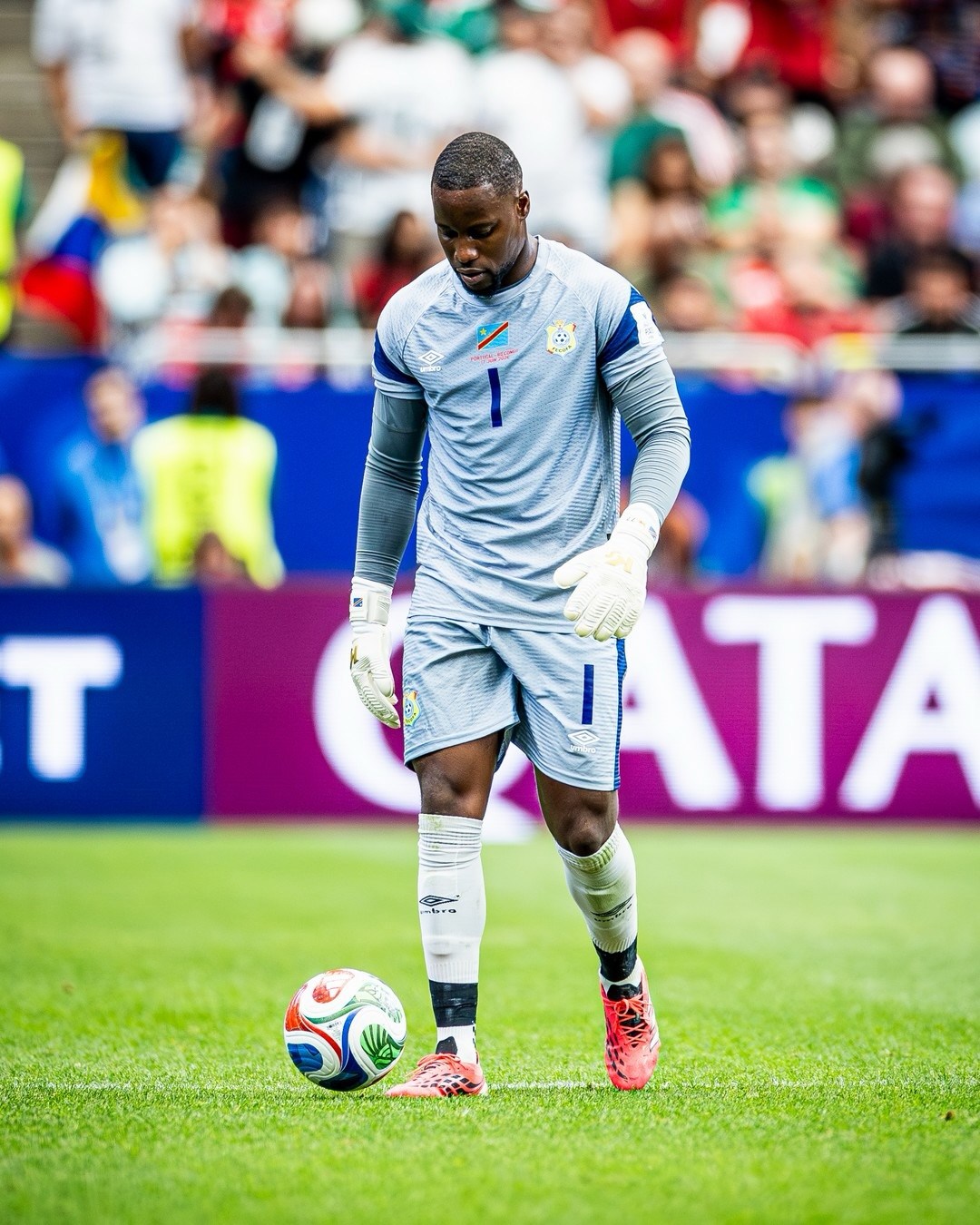 DR Congo goalkeeper Lionnel Mpasi in a grey jersey standing on the pitch during the FIFA World Cup 2026 group stage match against Portugal.