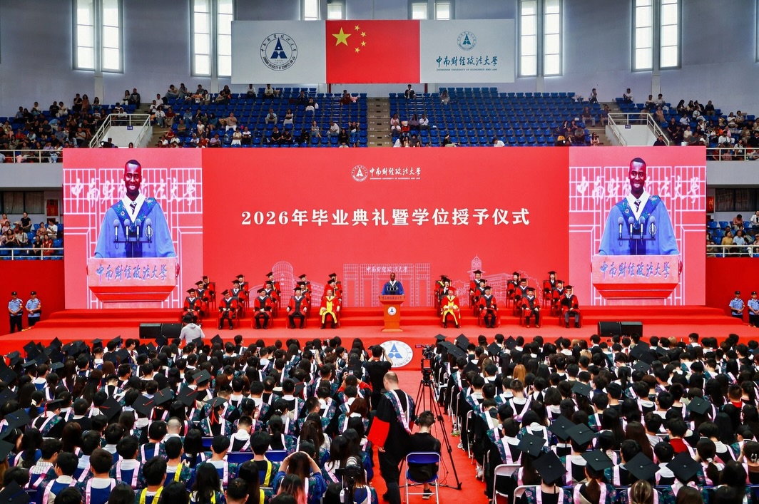 A wide view of the 2026 graduation ceremony hall at Zhongnan University of Economics and Law with digital screens displaying Nnabuike Chisom.