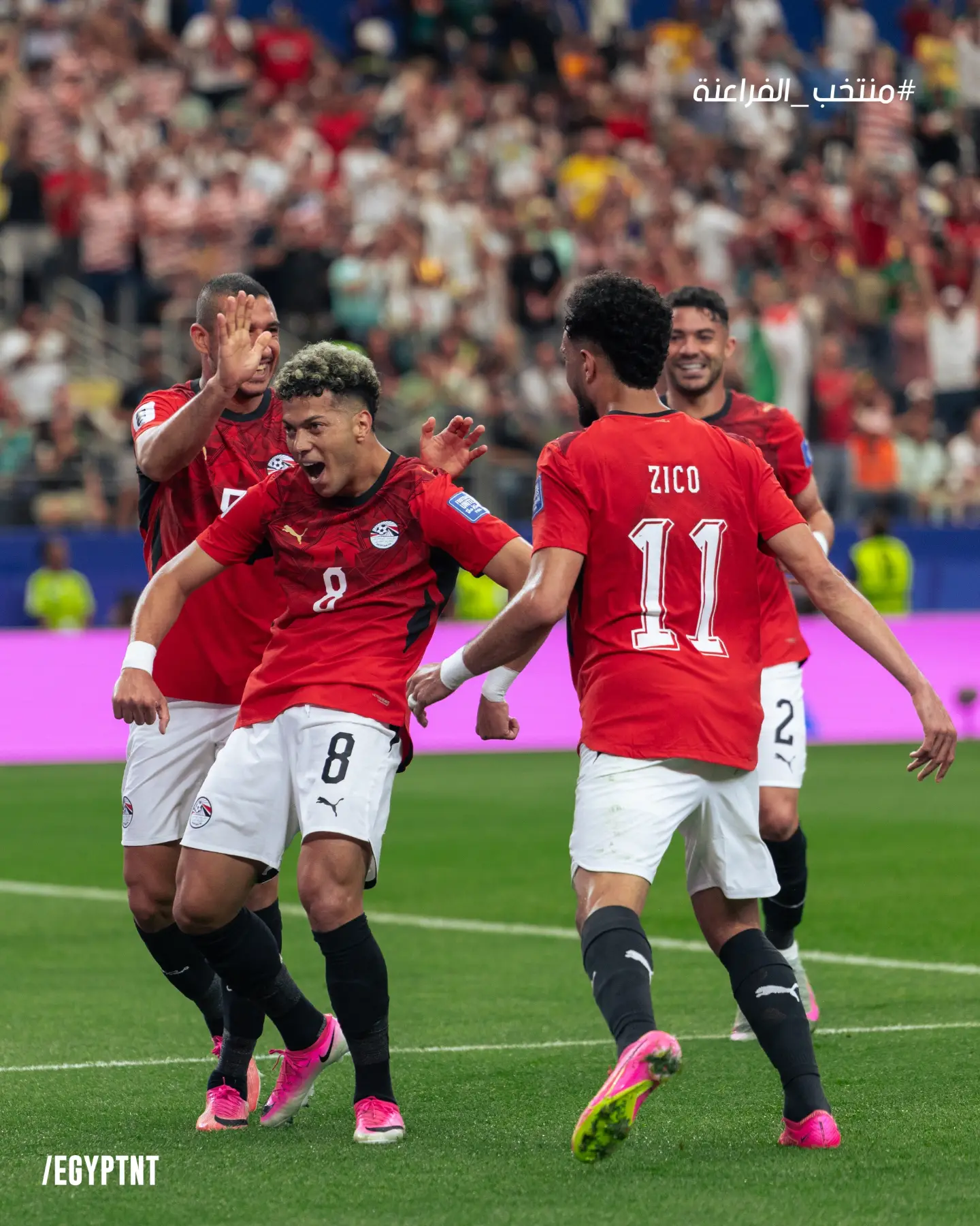 Egypt's Emam Ashour wearing the number 8 jersey celebrates scoring his second World Cup goal against Australia with teammates.
