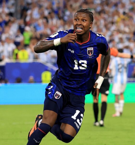 Sidny Lopes Cabral in the blue Cabo Verde kit sprinting down the football field during live match play.