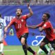 Yasser Ibrahim shouting in celebration after scoring Egypt's opening goal against Argentina with teammate Haissem Hassan.