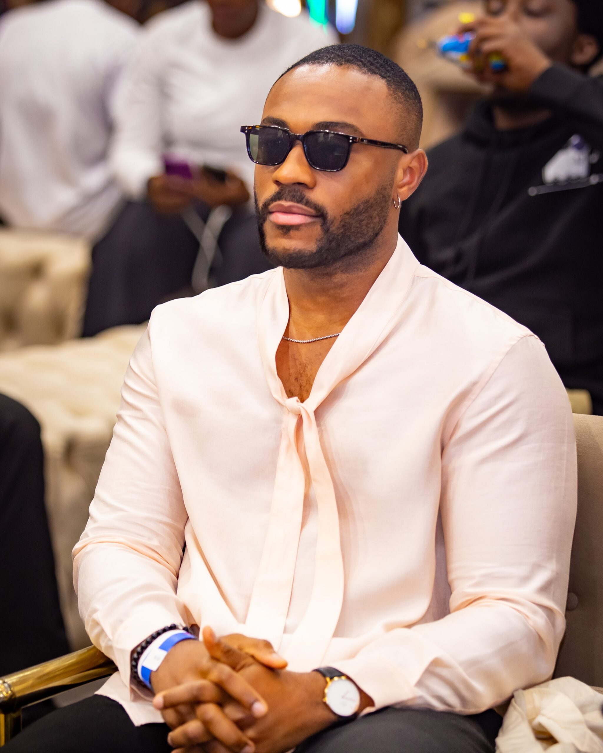 Big Brother Naija Season 10 ("No Loose Guard") finalist Kola Omotosho looking stylish in a pale pink silk shirt and sunglasses at the Big Brother Naija Season 11 press conference in Lagos, Nigeria.
