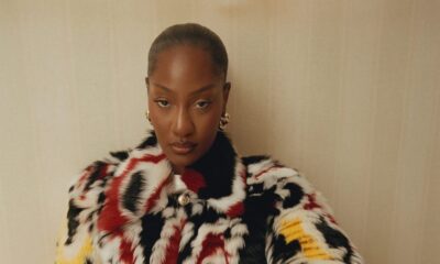 Tems wearing a patterned black, white, red, and yellow Chanel patchwork lambskin coat with gold LO Collections x Alex & Trahanas hoop earrings.