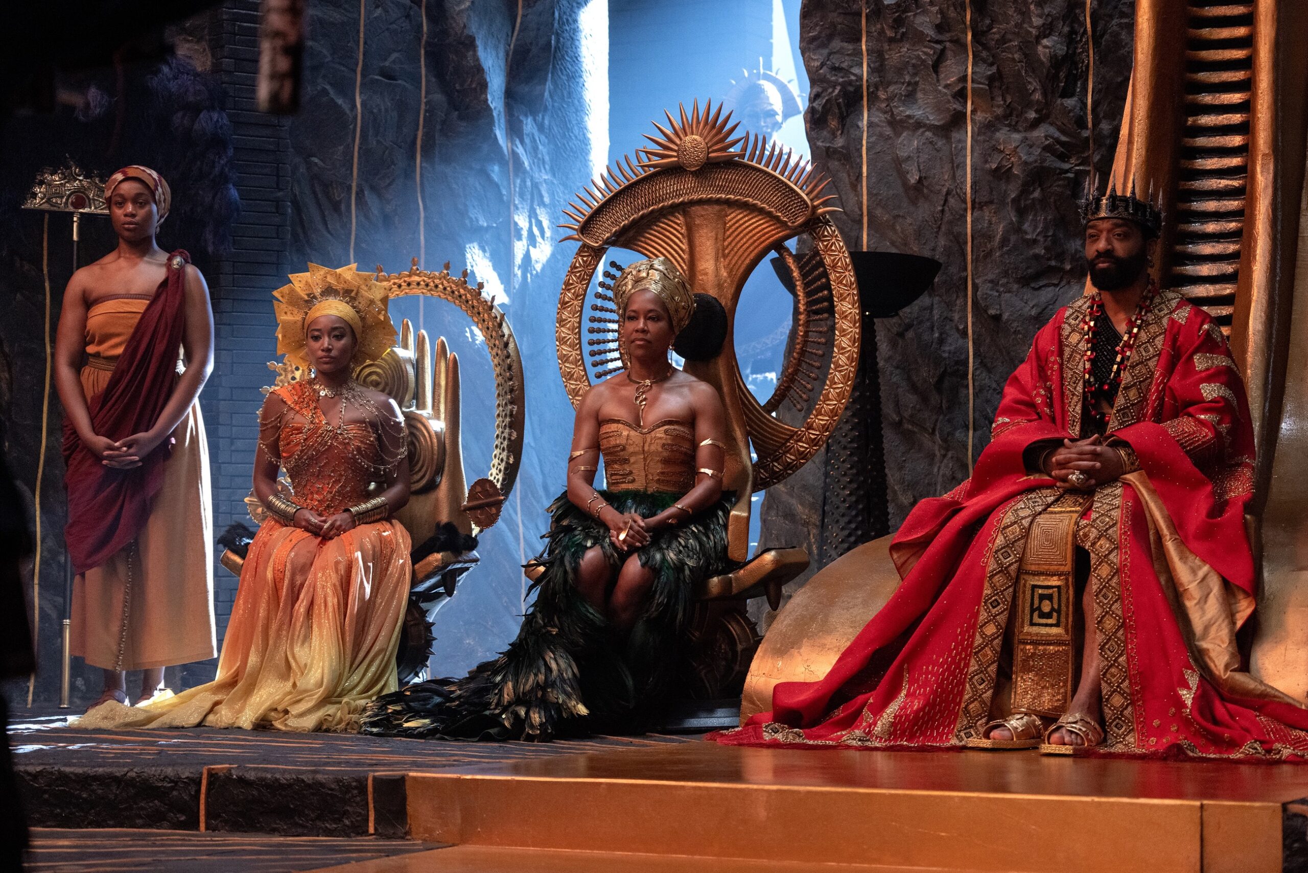 Chiwetel Ejiofor as King Saran, Regina King as Queen Nehanda, and Amandla Stenberg as Princess Amari seated on ornate golden thrones in the royal palace.