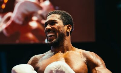 Anthony Joshua smiling in white Everlast boxing gloves inside the ring after his second-round knockout victory over Kristian Prenga at the Jeddah Superdome.