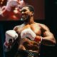 Anthony Joshua smiling in white Everlast boxing gloves inside the ring after his second-round knockout victory over Kristian Prenga at the Jeddah Superdome.