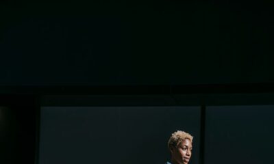 A confident stylish woman descends city stairs, embodying elegance and modern business fashion