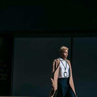 A confident stylish woman descends city stairs, embodying elegance and modern business fashion