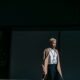 A confident stylish woman descends city stairs, embodying elegance and modern business fashion
