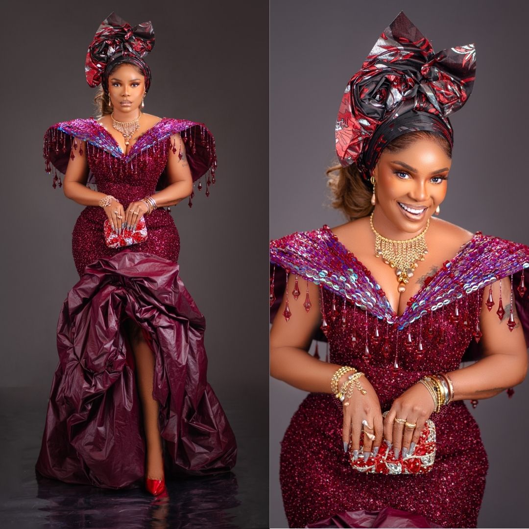 Iyabo Ojo wearing a deep burgundy embellished corset gown with a dramatic ruffled volume hem, crystal fringe neckline, and matching gele at Peller and Jarvis' traditional wedding.