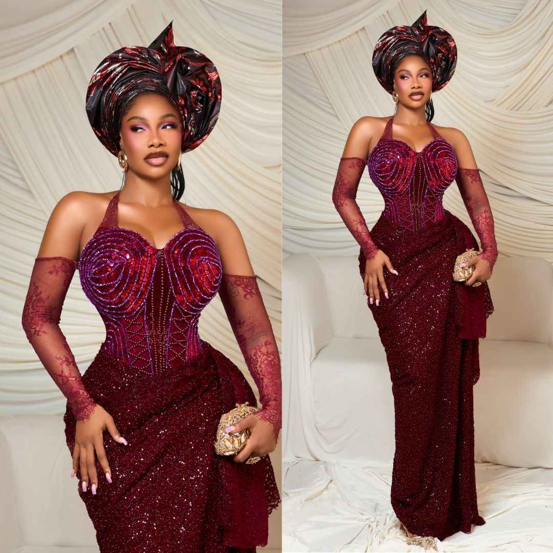 Tacha wearing a deep burgundy embellished lace corset gown with a halterneck, matching gele, sheer lace gloves, and a gold clutch bag at Peller and Jarvis' traditional wedding.