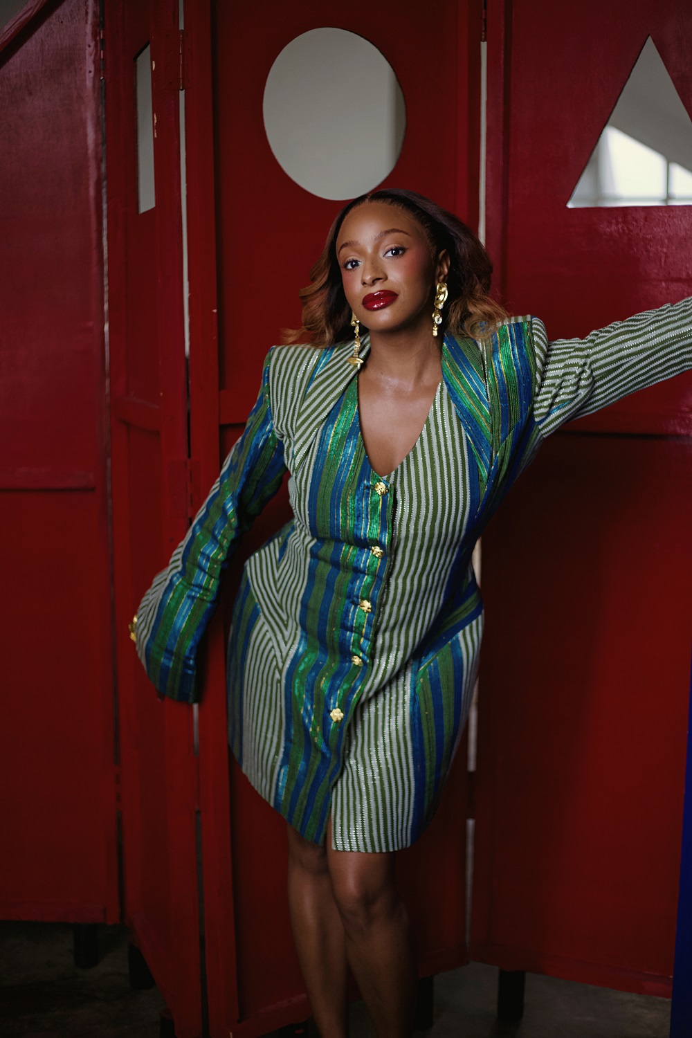 Florence Otedola wearing a tailored striped blazer dress symbolising her transition from Afrobeats performer to global SDG advocate and philanthropist.