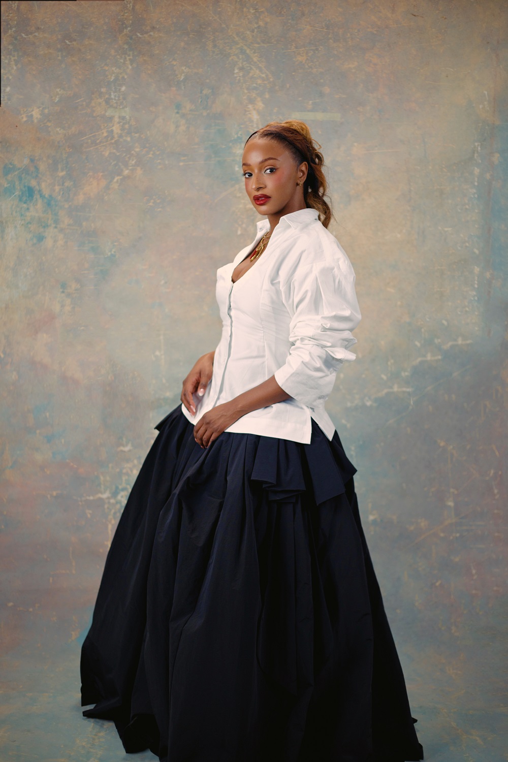 Florence Otedola wearing a structured white shirt and full black skirt reflecting her choice to shed public expectations and performative identity.