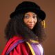 Professor Ogechi Adeola wearing academic doctoral regalia and cap representing the University of Kigali and AD Scientific Index research excellence.
