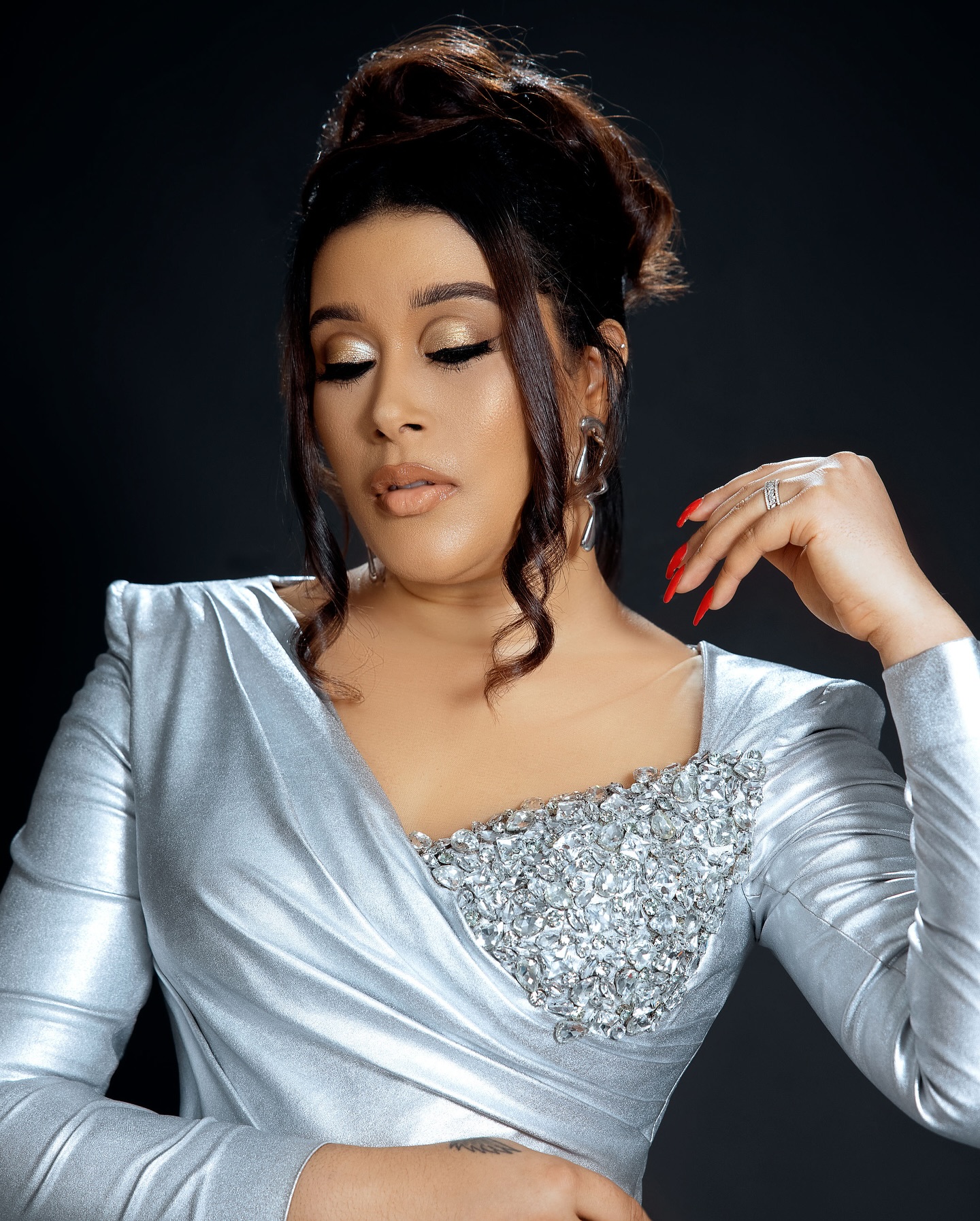 Adunni Ade wearing a silver embellished metallic long-sleeve outfit