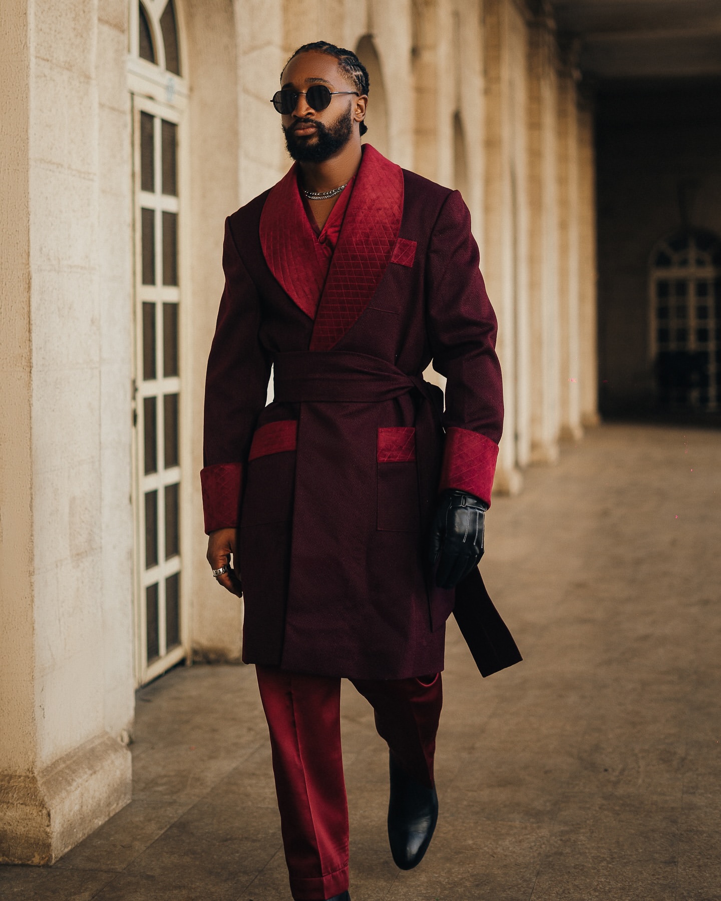 Chimsom Chuka wearing a burgundy velvet robe coat and matching trousers at the 2026 AMVCA red carpet.