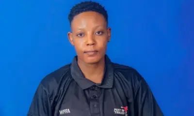 Evelyn Okafor posing with a football in an official WFFA tournament kit