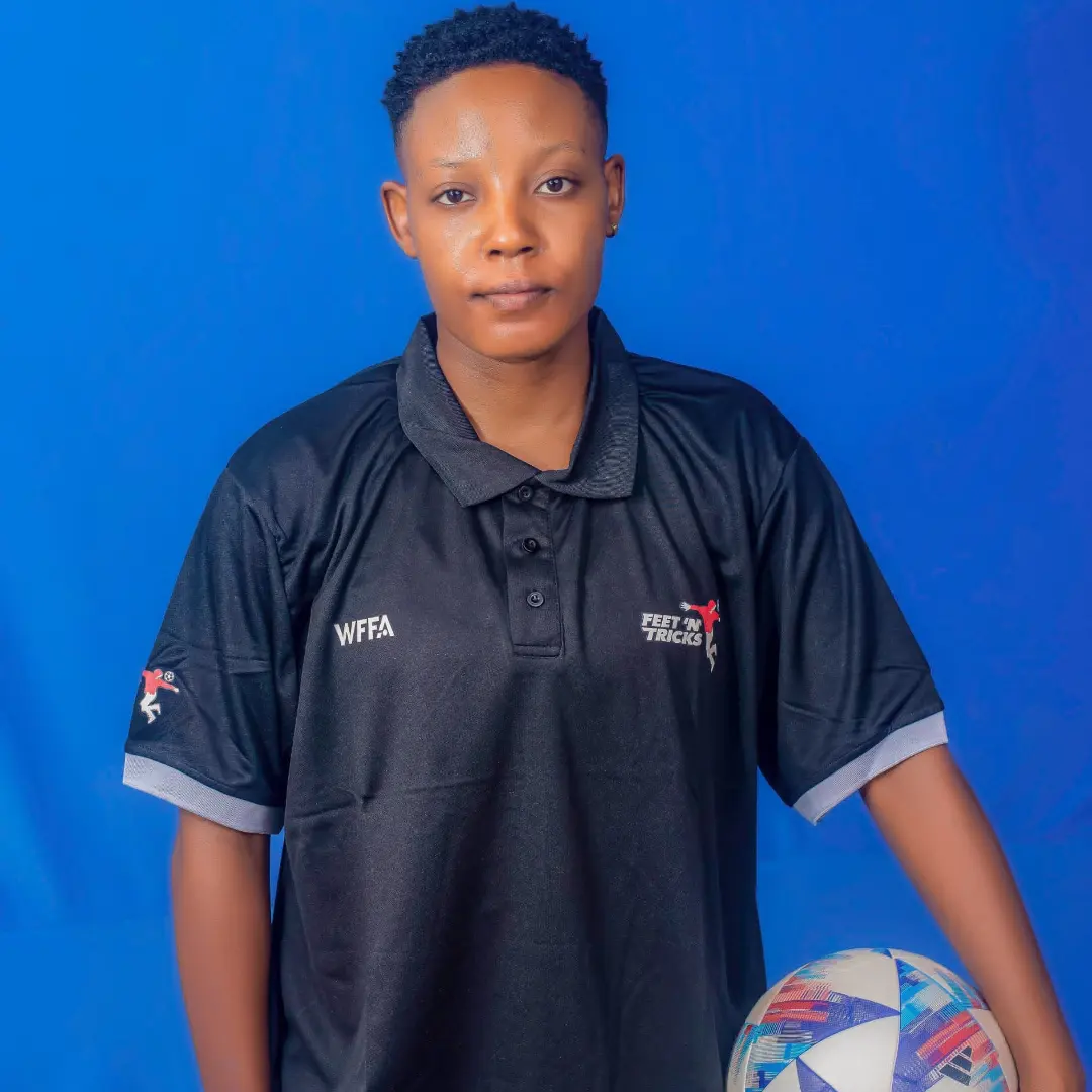 Evelyn Okafor posing with a football in an official WFFA tournament kit