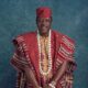 Memorial photo of Nollywood actor Taiwo Hassan Ogogo wearing traditional red Aso-Oke Agbada and white coral beads.