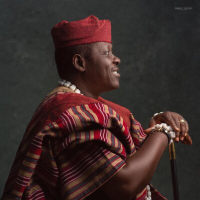 Profile view of pioneer Nollywood actor Taiwo Hassan Ogogo in traditional Aso-Oke Agbada.