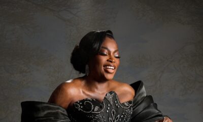 Nollywood actress Funke Akindele smiling in an embellished black corset gown with statement exaggerated sleeves.