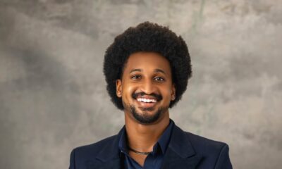BBNaija housemate Chimsom Chuka posing in a navy blue double-breasted suit jacket with an afro hairstyle.