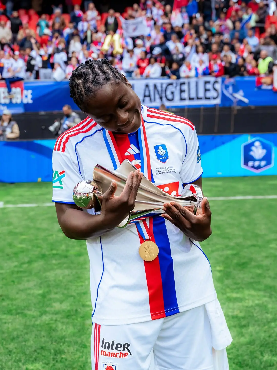 Tabitha Chawinga cradling a silver tr