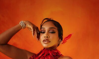 Uche Montana wearing a red and gold feathered Tubo dress at the 2026 AMVCA.