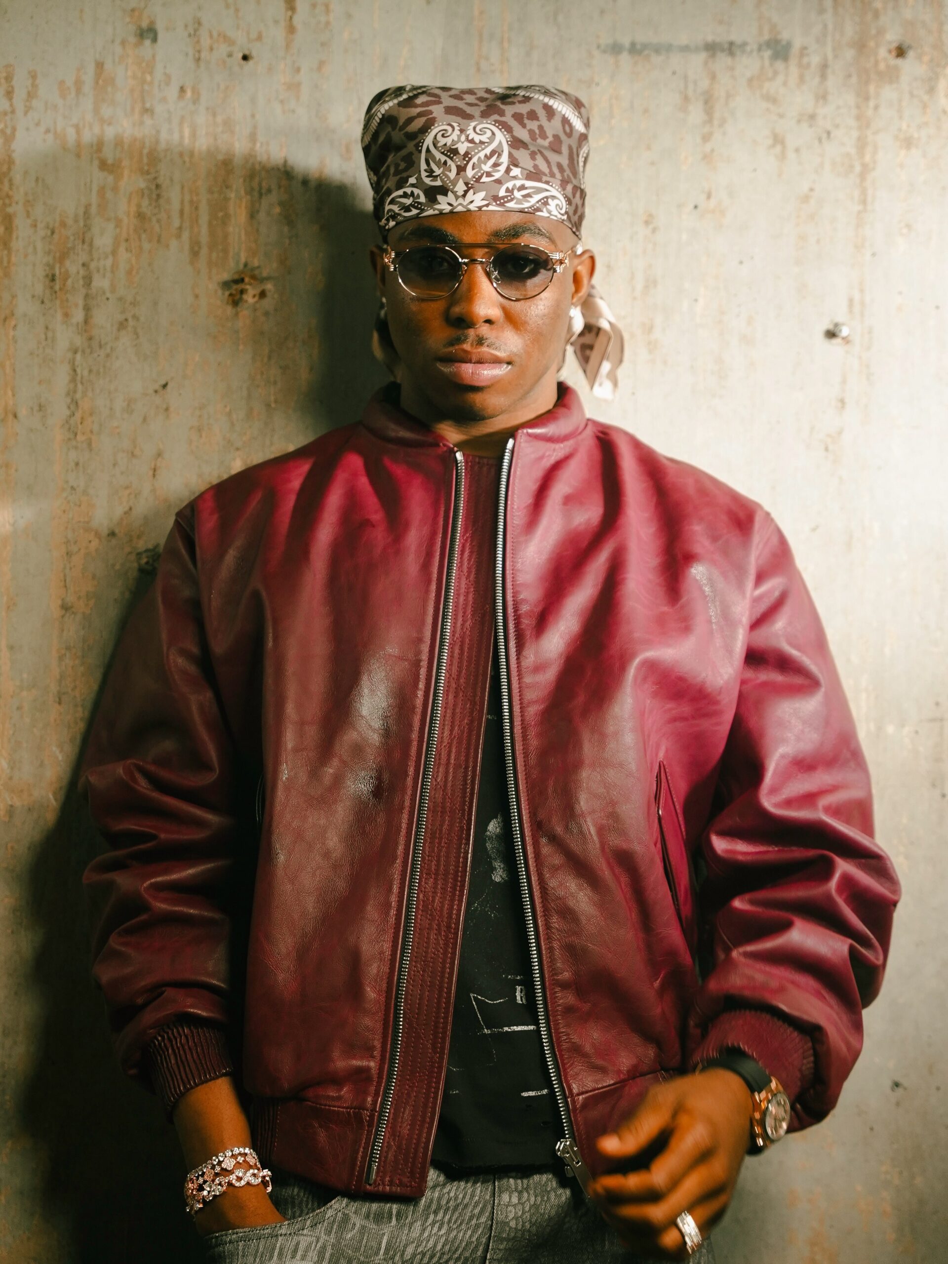 Fola wearing a bandana, sunglasses, and red leather jacket following his 10 nominations at the 2026 Headies Awards.