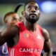 Cameroonian sprinter Emmanuel Eseme wearing a red Cameroon jersey with his race bib at the 2026 Commonwealth Games in Glasgow.
