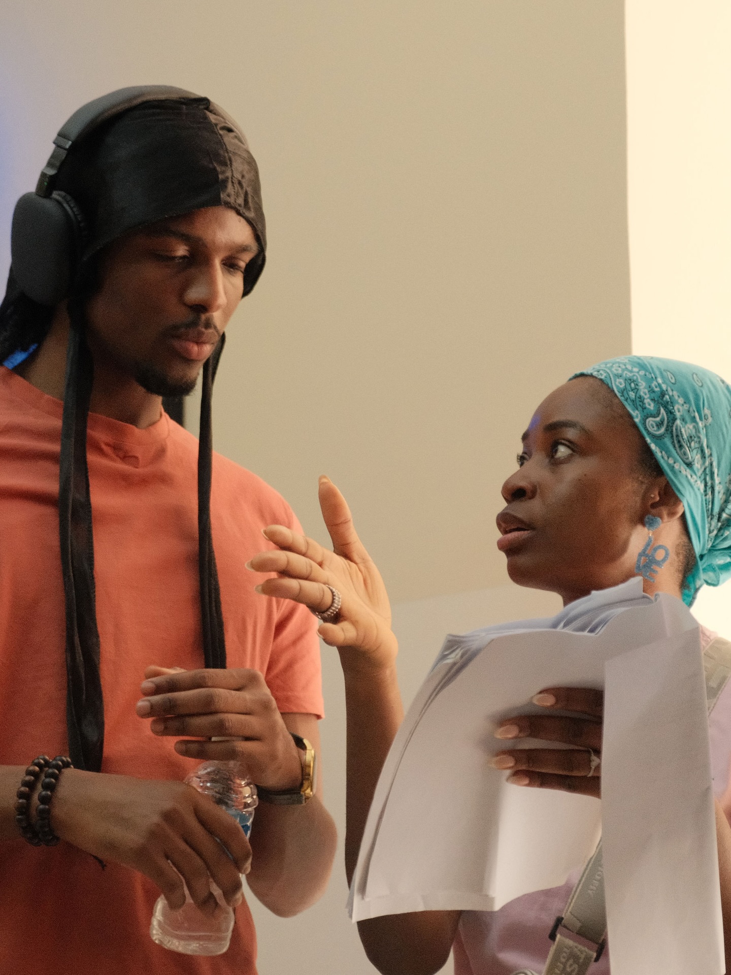 Director Uzoamaka Power holding script pages while reviewing dialogue with actor Natse Jemide on the set of Siraam.